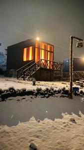 a building covered in snow in front at WorthMiles Resort in Manāli