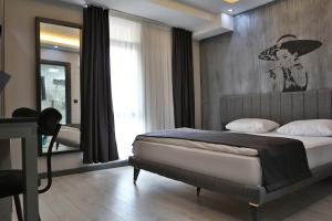 a bedroom with a bed with a painting on the wall at Fly And Stay Airport Hotel in Istanbul