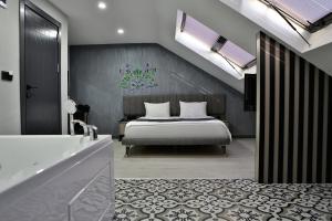 a bedroom with a bed and a tub and a sink at Fly And Stay Airport Hotel in Istanbul