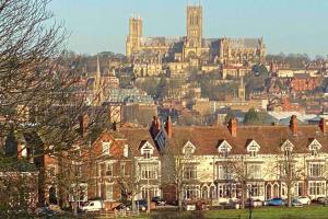 a large building with a city in the background at Cosy Homely Apartment close to Lincoln City Centre in Lincoln