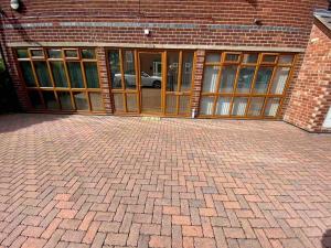 a brick building with glass doors on a brick floor at Cosy Homely Apartment close to Lincoln City Centre in Lincoln