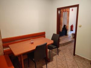 a dining room with a wooden table and chairs at Turistična kmetija Štupar in Dvor +2 photos
