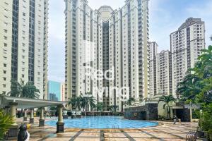 a swimming pool in front of tall buildings at RedLiving Apartemen Mediterania Palace - Meditrans Property Tower B in Jakarta