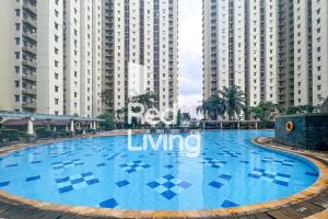 a large swimming pool in front of tall buildings at RedLiving Apartemen Mediterania Palace - Meditrans Property Tower B in Jakarta