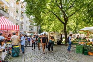 a group of people walking through a street market at Schillinger-Berlin am Tempelhofer Feld in Berlin