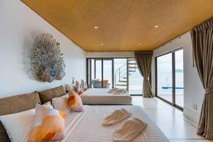 Postel nebo postele na pokoji v ubytování Marine Stay Pool Villa 300yod ปราณบุรี-สามร้อยยอด บ้านพักติดทะเล พูลวิลล่าติดทะเล + 37 fotografií