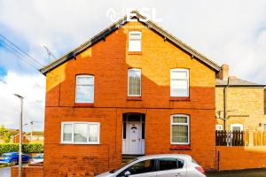 a red brick house with a car parked in front of it at Stylish 3 Bedroom Townhouse close to Chester City Centre - Ideal for Families, Groups and Contractors in Hough Green
