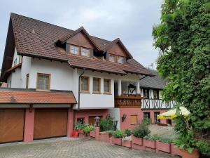 a white and red house with a garage at Linde Diersburg Stammhaus in Diersburg