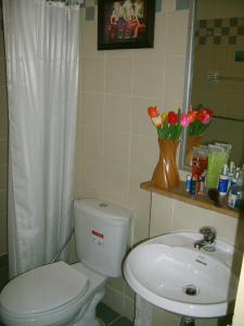 a bathroom with a toilet and a sink at Keerawadee Two Bedroom House 