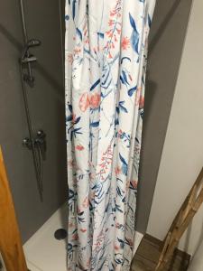 a shower curtain with a blue and red flower pattern at Moulin sous la Vergne in Nanteuil-en-Vallée +53 photos