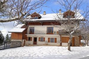 a house with snow on the ground in front of it at Gîte Cœur de Haute-Savoie in Viuz-en-Sallaz +15 photos