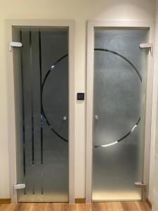 a glass door with a circle in the middle at Dohany utca 1b ,Luxury apartment in Center in Budapest