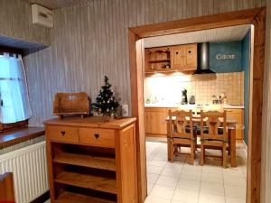 a kitchen and dining room with a christmas tree in it at Gîte Cœur de Haute-Savoie in Viuz-en-Sallaz