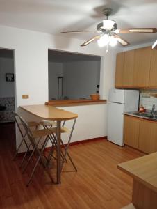 a kitchen with a table and a white refrigerator at Appartamento Malcontenta in Mira