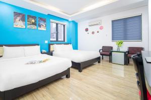 Postel nebo postele na pokoji v ubytování La Maison Danang Beach Hotel