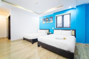 Postel nebo postele na pokoji v ubytování La Maison Danang Beach Hotel