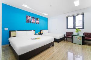 Postel nebo postele na pokoji v ubytování La Maison Danang Beach Hotel