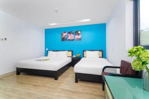 Postel nebo postele na pokoji v ubytování La Maison Danang Beach Hotel