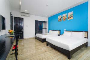 Postel nebo postele na pokoji v ubytování La Maison Danang Beach Hotel