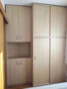 a large closet with wooden cabinets in a room at Odmor u Zagrebu in Zagreb