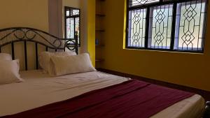 Postel nebo postele na pokoji v ubytování Muffys Guest House