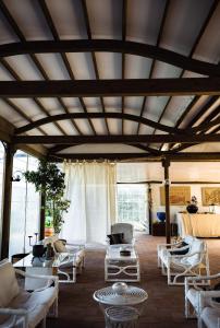 a living room with white chairs and tables at Giardino dell'impossibile di Antonino Campo in Favignana