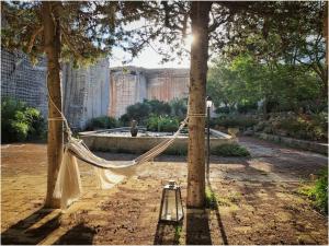 a hammock hanging between two trees in a park at Giardino dell'impossibile di Antonino Campo in Favignana