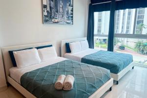 two beds in a room with a window at Miami Beach Apartments by MiaRentals in Miami Beach