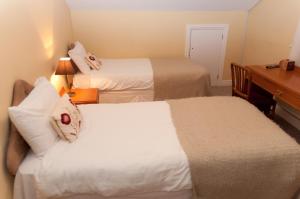 a hotel room with two beds and a desk with a desk at Oak Inn in Upton Snodsbury