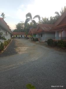 una entrada vacía delante de algunas casas en Baan Khunta Resort, en Khura Buri