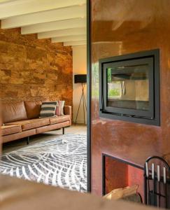 a living room with a couch and a television on a wall at WaddenParels Zoet in Midsland