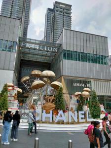 a group of people standing in front of a building at Pavilion Fahrenheit 88 Bukit Bintang 3 bedrooms in Kuala Lumpur
