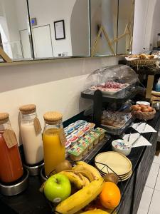 a counter with a bunch of fruit and juice at Hôtel Bonne Nouvelle in Paris