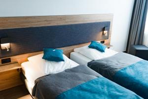 Postel nebo postele na pokoji v ubytování Hotel Am Park
