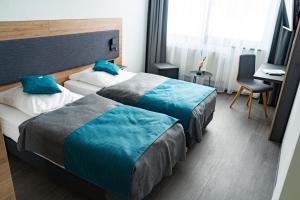 Postel nebo postele na pokoji v ubytování Hotel Am Park