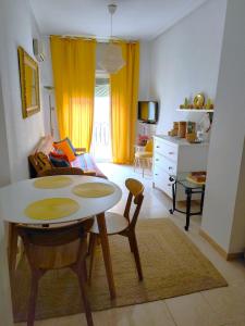 a living room with a table and a bedroom at Casco histórico in Alicante