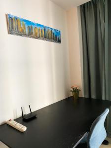 een zwarte tafel met een afstandsbediening erop bij Exquisite Spacious Deluxe one bedroom Apartment, Stunning Marina Views, Full Kitchen High-Speed Internet, Dubai Marina Gem, By "La Buena Vida Holiday Homes" in Dubai