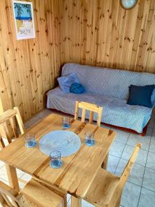 um quarto com uma mesa de madeira e um sofá em Domki wczasowe u Ewy em Chłopy