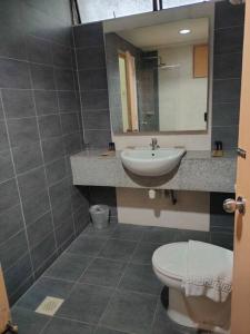 a bathroom with a sink and a toilet and a mirror at Pavilion Fahrenheit 88 Bukit Bintang 3 bedrooms in Kuala Lumpur