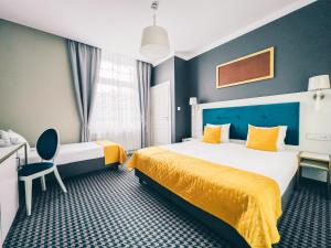 Łóżko lub łóżka w pokoju w obiekcie Hotel Villa Art Novis City Center
