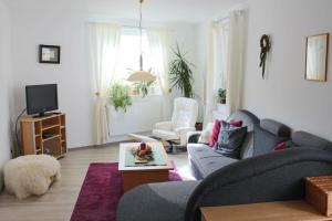 een woonkamer met een bank en een tv bij Ferienwohnung Backhaus in Goslar