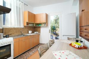 a kitchen with a table and a dining room at Meji House in Skala Kallirakhis