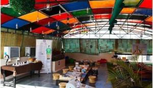 a room with a multicolored ceiling and a room with tables at Heistel Delhi in New Delhi