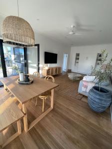 a living room with a table and a couch at Skipper’s Lakes Entrance *Waterfront* in Lakes Entrance