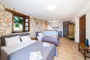 a hotel room with two beds and a window at Abeloklima country house in Vasilikos