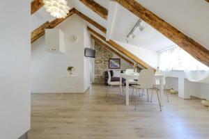 a dining room with a white table and chairs at Luxury Deluxe Apartment in Dubrovnik