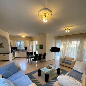 a living room with a couch and a table at Excellent 3 storey villa with a swimming pool in Belek