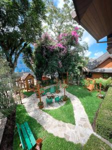 um quintal com uma mesa de piquenique e uma árvore em Hotel Vovó Carolina em Gramado