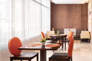 a dining room with two tables and chairs at Catalonia El Retiro in Madrid