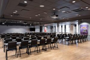 a large room with chairs and a podium in it at Scandic Ambassadeur Drammen in Drammen